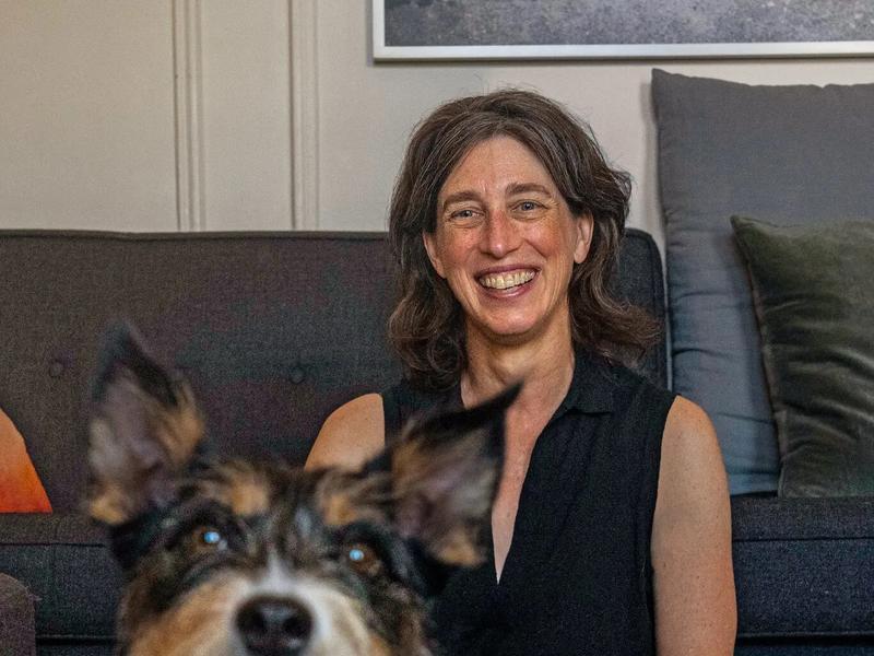 Alexandra Horowitz sitting with new dog in her living room